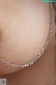 A close up of a woman wearing a silver chain necklace.