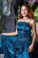 A woman in a blue dress posing for a picture.